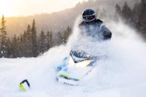 Snowmobile rider in a fresh powder snow